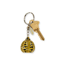 Load image into Gallery viewer, A yellow and black spotted keychain charm with a silver split ring, attached to a brass key and a small white tag, shown on a plain white background.
